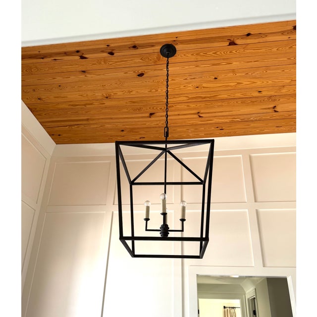 Enormous Currey & Company Denison Black Large Hanging Lantern in a hammered wrought iron featuring a Mole black finish....