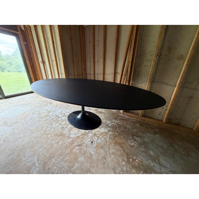 Knoll Saarinen oval dining table, designed by Eero Saarinen. Large 96-inch version with black laminate oval top and iconic...