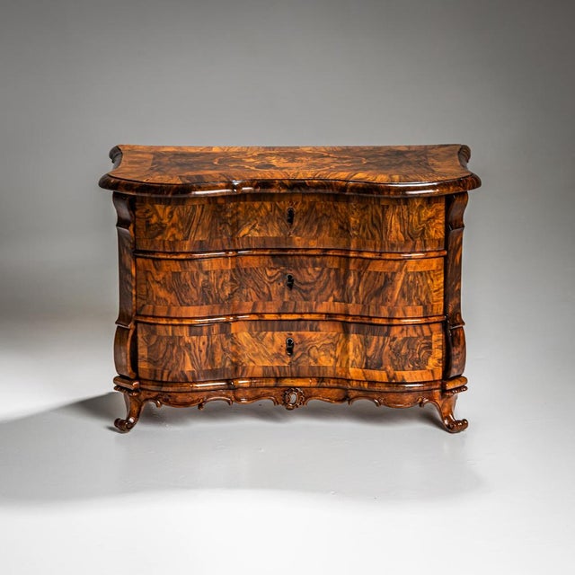 This exquisite mid-18th-century miniature chest of drawers showcases masterful craftsmanship. It rests on elegantly curved...
