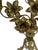 This is an antique French brass candelabra featuring an elaborate arrangement of sculpted lilies and foliage rising from a...