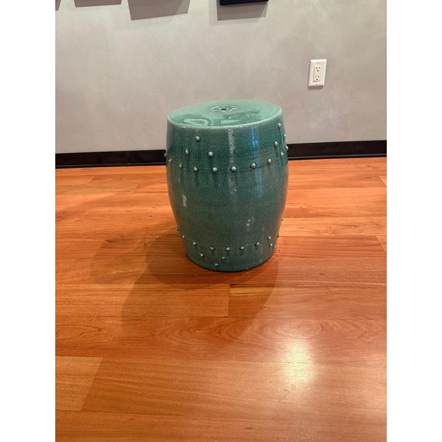 eautiful ceramic garden stool featuring a classic celadon green crackle glaze with raised stud detailing. The barrel/drum...