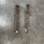A pair of sculptural classic mid-20th Century modern style wall candlesticks. These tall wire-sculpted candlesticks would...