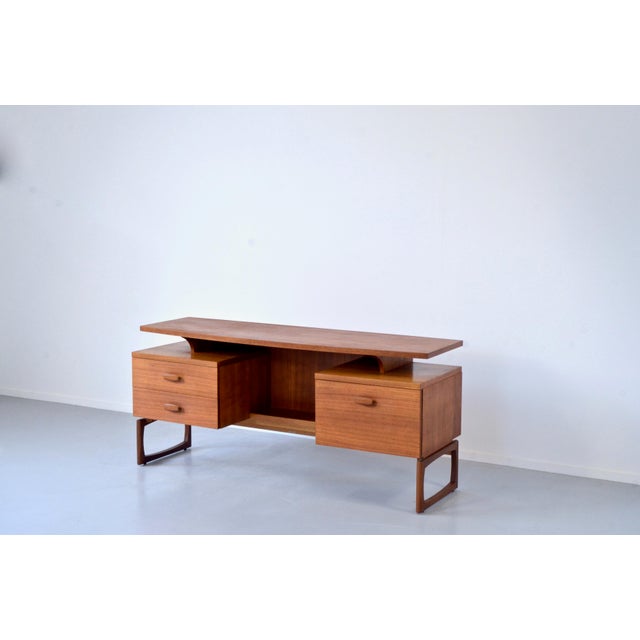 Teak Desk with Floating Top from G-Plan, 1960s, in Very Good conditions. Designed 1960 to 1969 This piece has an...