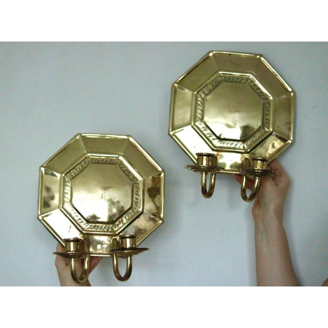 Pair of Swedish Brass Octagonal Double Arm Sconces Elegant Swedish brass wall sconces with a rare octagonal backplate and...