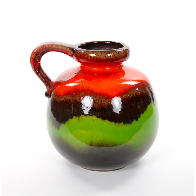 A striking mid-century West German drip lava glazed porcelain vase, beautifully showcasing the bold colors and modernist...
