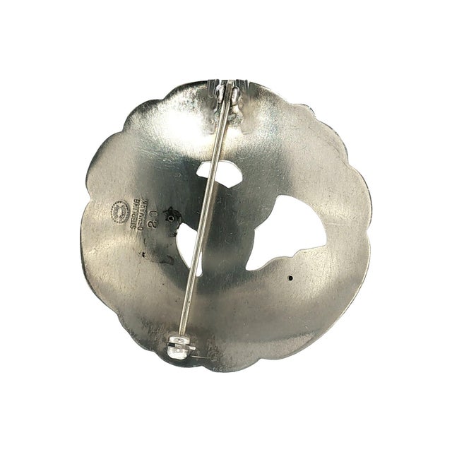 A mid-century sterling silver design #20 brooch by Georg Jensen. Crafted in Denmark. The design features swirling, organic...