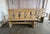 This striking pair of hand-carved wooden benches showcases a bold rustic character with sculptural silhouette details and...