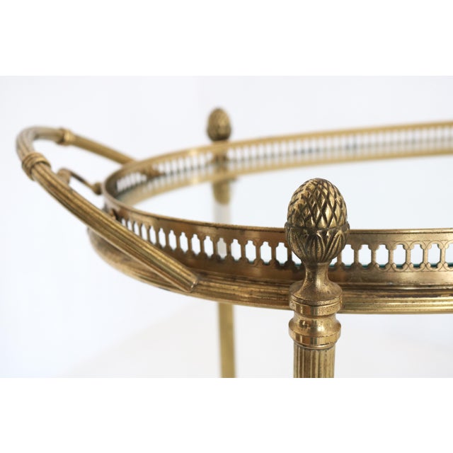 Elegant oval brass and glass bar cart, attributed to Maison Baguès and dating from the 1950s. A refined example of French...