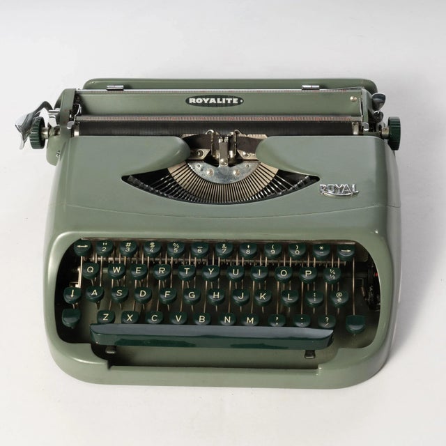 This Vintage Royalite Typewriter was manufactured in the 1950's with a grey-green base and forest green keys. The...
