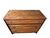 A distinctive vintage chest with warm oak drawer fronts set against a black-painted case. Carved foliate details between...
