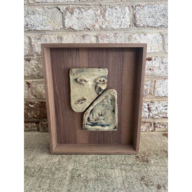 Pair of abstract speckled ceramics with raised features mounted in a custom raw walnut frame. The artist of these vintage...