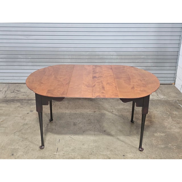 Store Item: Tiger Maple Benchmade Dining Table Black Painted Base 2 Leaves Description: Shaped table top of solid tiger...