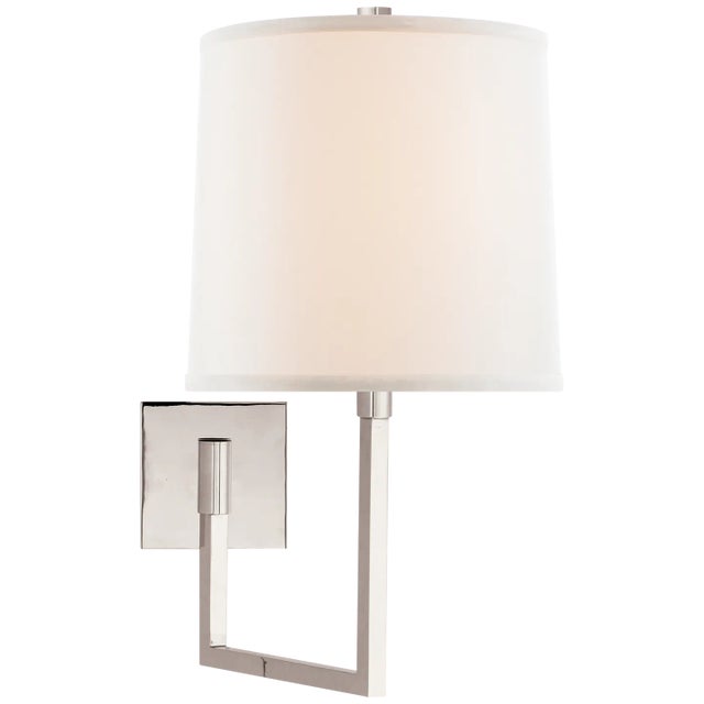 Aspect Large Articulating Sconce in Polished Nickel with Ivory Linen Shade Designer: Barbara Barry Height: 18.5"...