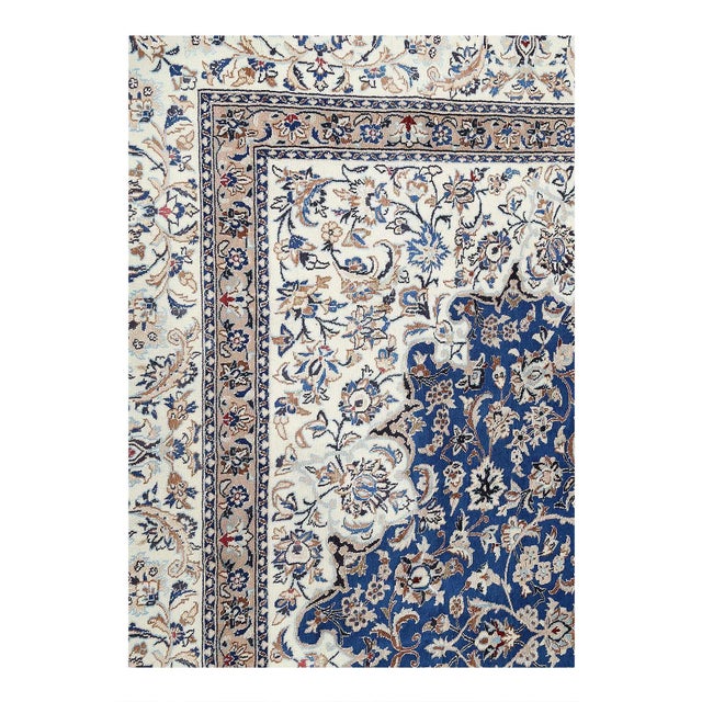 Persian Nain rugs are renowned for their detail and fine use of outlining along the central motifs. Breaking from the...