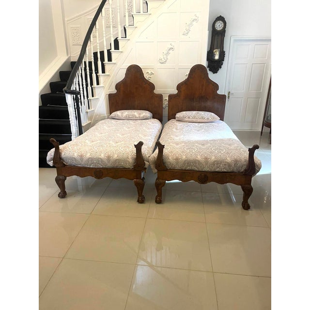Antique pair of fine quality carved burr walnut single beds in the Queen Anne style having attractive shaped burr walnut...
