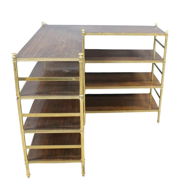 A pair of corner etageres of brass and wood from quintissential artisans P. E. Guerin. Crafted by pioneers in luxury...