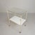 This serving trolley has 2 different glass shelves. A white one at the bottom and a transparent one at the top. They can,...