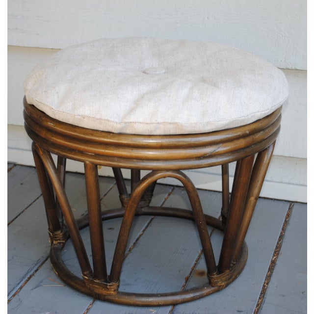 This vintage bamboo/rattan ottoman has a new cushion made of tweed in the style of the mid century original cushion. The...