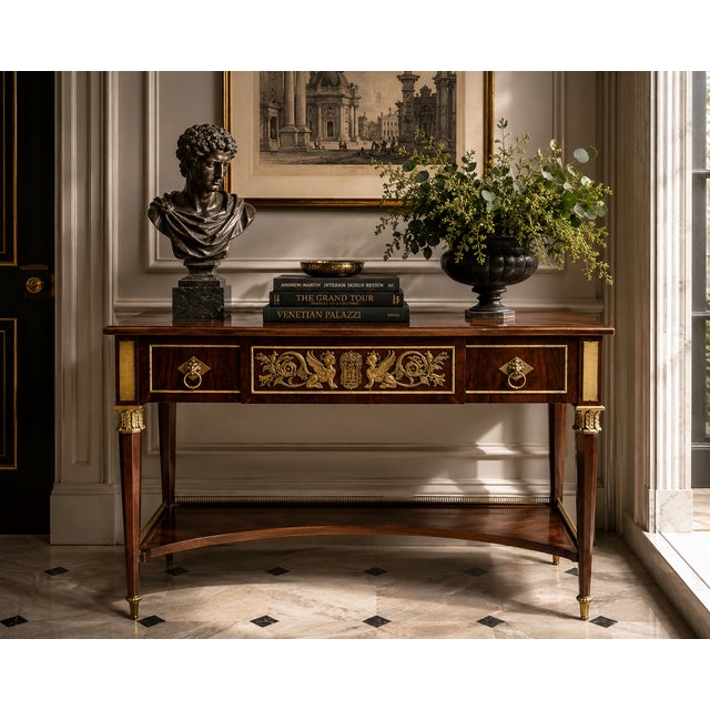 An elegant neoclassical console table by renowned American maker John Widdicomb, showcasing the exceptional craftsmanship...