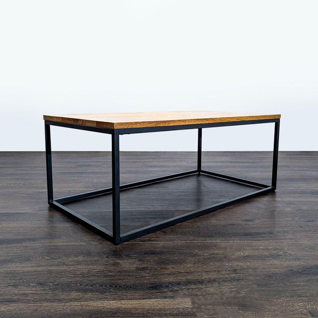Industrial style table with a wood top on a blackened steel base. Brand: West Elm. Dimensions (in): 44W x 24D x 18H.