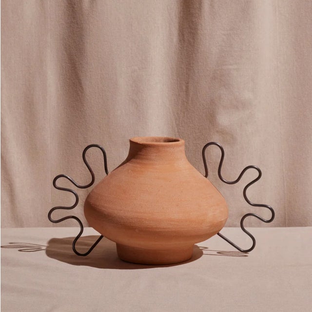 The Ines Terracotta Vessel by Diego Olivero Studio for Meso Goods is a striking sculptural accent handcrafted by artisans...