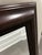 A rectangular wall mirror with a warm, dark mahogany-style wood frame, clean simple molding, and a beveled mirror center....