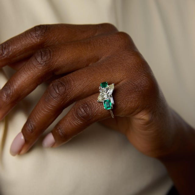 A striking Mid Century design, this vintage platinum ring centers on a dramatic 1.98 carat marquise cut diamond certified...