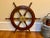 An authentic varnished mahogany six-spoke ship or yacht wheel with a solid brass hub and outer ring. Product Information:...