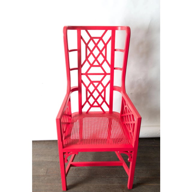 A statement piece wood fretwork Chinese Chippendale chair painted in Chinese red with caned seat. In very good condition.