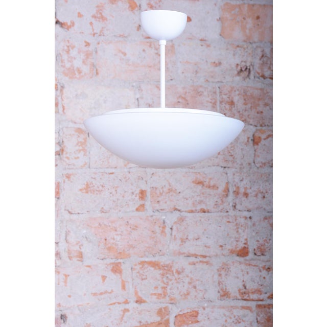 This minimalist pendant chandelier originates from 1960s Czechoslovakia and is the essence of "Mid-Century" aesthetics....