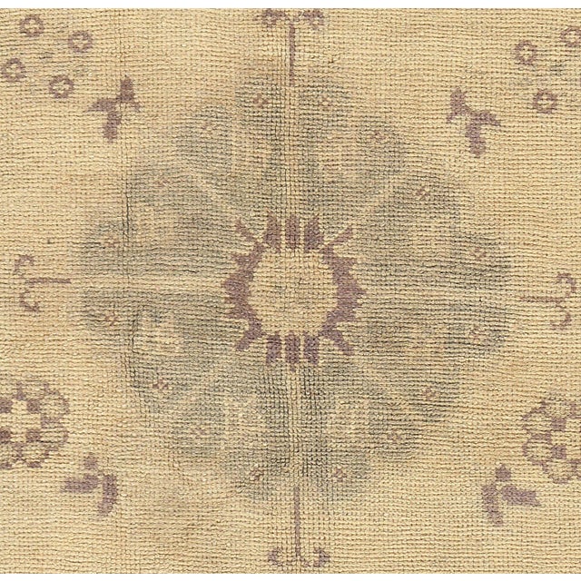 This vintage Turkish Oushak runner showcases traditional craftsmanship, handwoven from wool with a classic medallion...