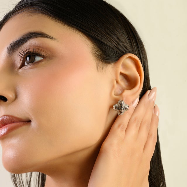 These sophisticated solid silver stud earrings feature a timeless quatrefoil floral motif, elegantly accented with...