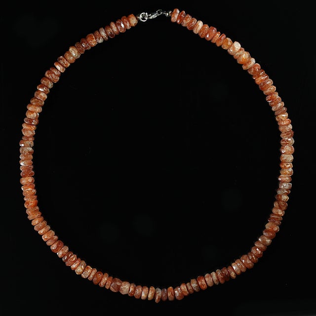 This elegant 17‑inch sunstone necklace showcases a strand of finely faceted 7 mm rondelles, each one catching the light...