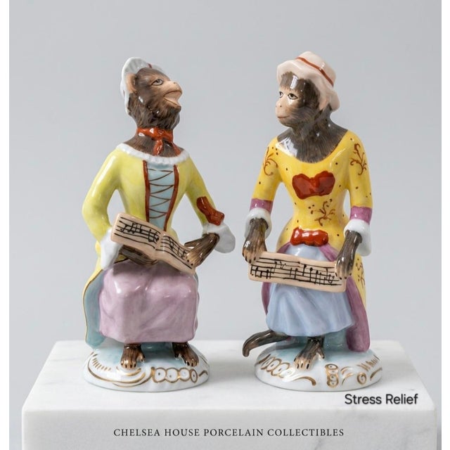 A charming pair of Chelsea House porcelain Monkey Band singer figurines inspired by the celebrated Meissen Affenkapelle...