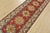 A tribal Caucasian Kazak runner hand-knotted with fine wool on a cotton foundation. This rug has a row of geometric...