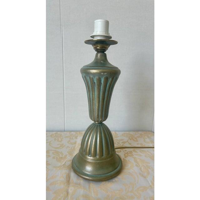 Ceramic lamp from the 1950s. Tiffany blue ceramic, hand-decorated with gold brushstrokes. Original brass detail. The lamp...