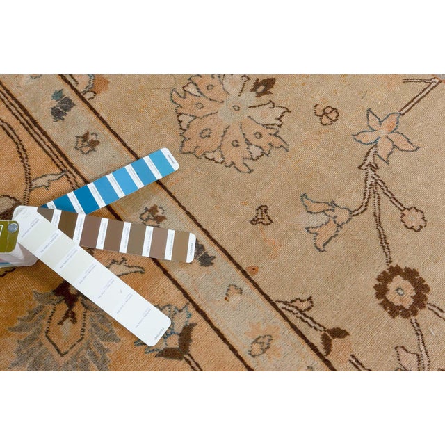 An early 20th century Persian Antique Tabriz rug, the camel field with a spacious design of delicate scrolling flowering...