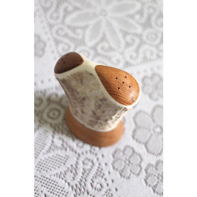 An interesting salt and pepper shaker that is made of antler and has one side for salt and one for pepper. You tip the...