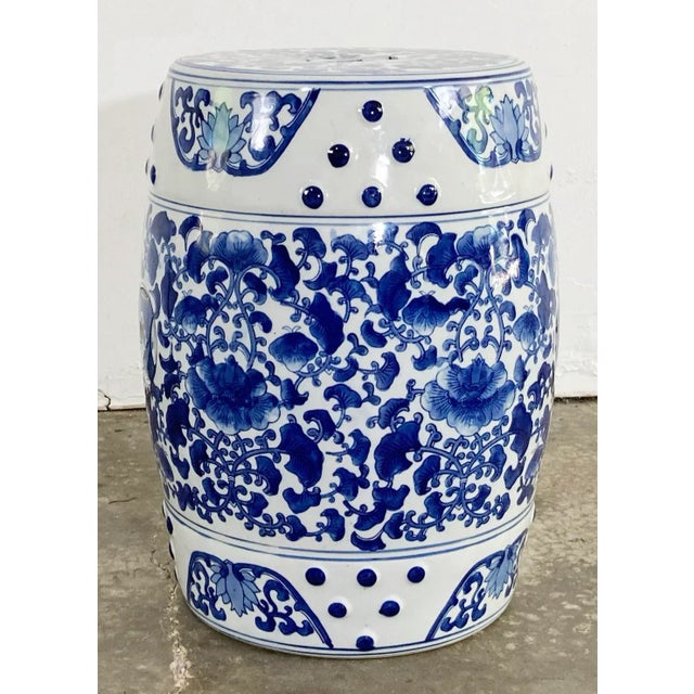 Vintage ceramic garden stool featuring traditional Chinese patterns of blue and white lotus flowers. Classic drum shape...
