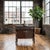 This compact antique cabinet reflects the late American Empire Revival style, with a bowed front and rich dark-stained...