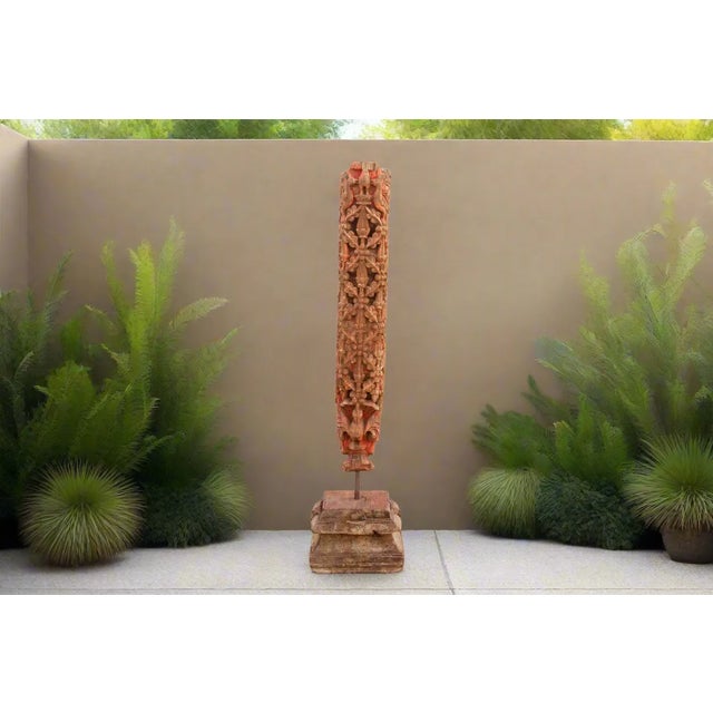 A tall antique carved wooden corbel that was once used as a support of outside frieze of a haveli in Mandawa. It features...