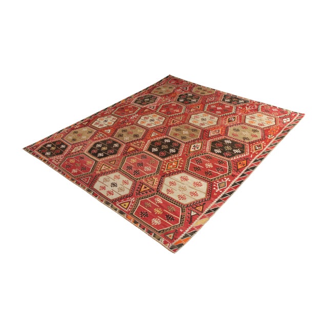 Handmade in flat woven wool originating from Turkey circa 1950-1960, this mid-century rug is a vintage Kilim rug of a...