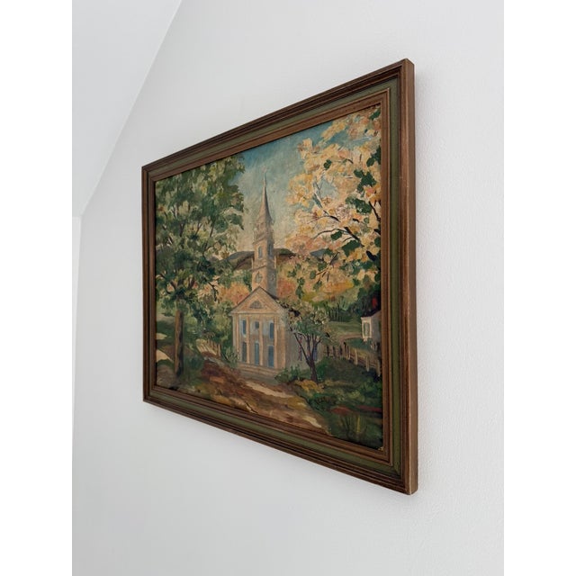 A mid-century American landscape painting depicting a classic New England church, done in oil on canvas board. Likely...