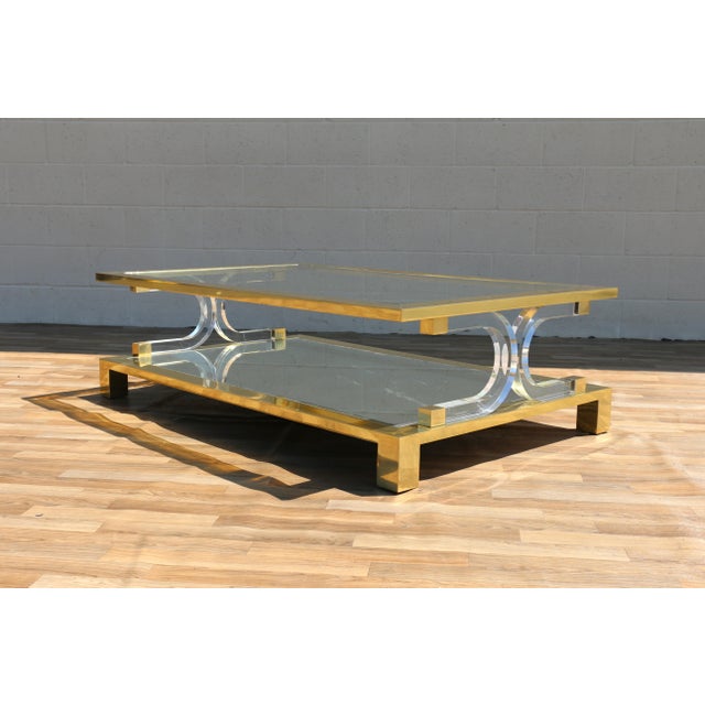 Striking Hollywood Regency two-tier coffee table, circa 1970s, in the style of Charles Hollis Jones. Features a polished...