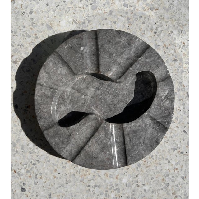 A monumental incredibly unique vintage Italian marble ashtray, circa 1970. Featuring an undulating edge with ten rivulets...