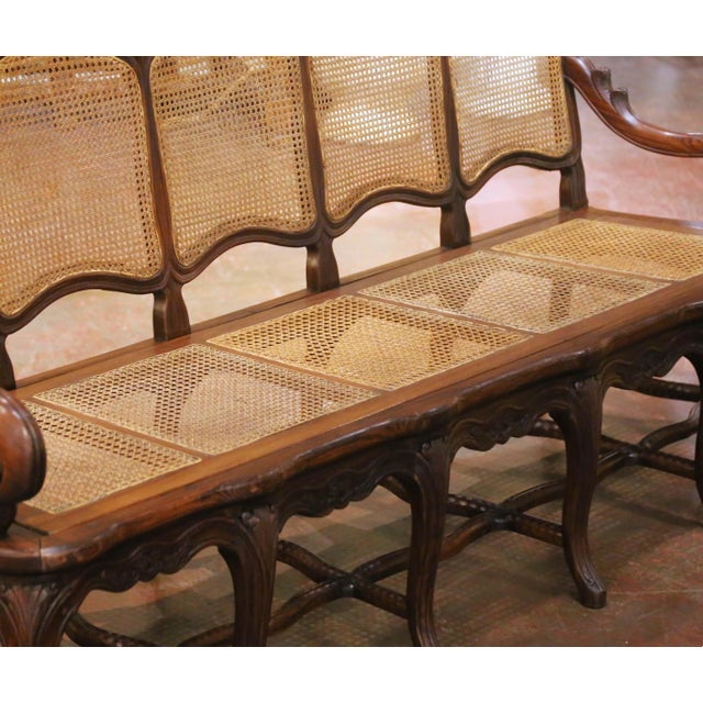 Decorate a hallway, living room, sunroom, or large bedroom with this elegant antique five-seat caned settee. Crafted in...