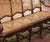 Decorate a hallway, living room, sunroom, or large bedroom with this elegant antique five-seat caned settee. Crafted in...