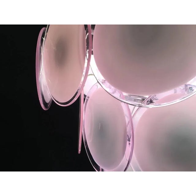 The 24 pink discs of precious Murano glass are arranged on floor levels. Nine lights. This piece is attributed to the...