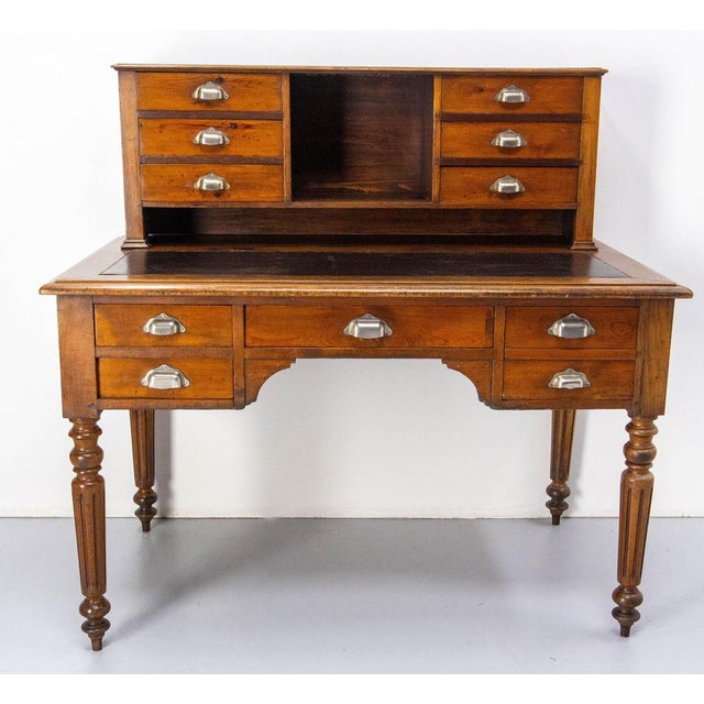 French 19th century Louis Philippe pine desk, the top is recovered of coated fabric. Ten drawers of different size. Table...