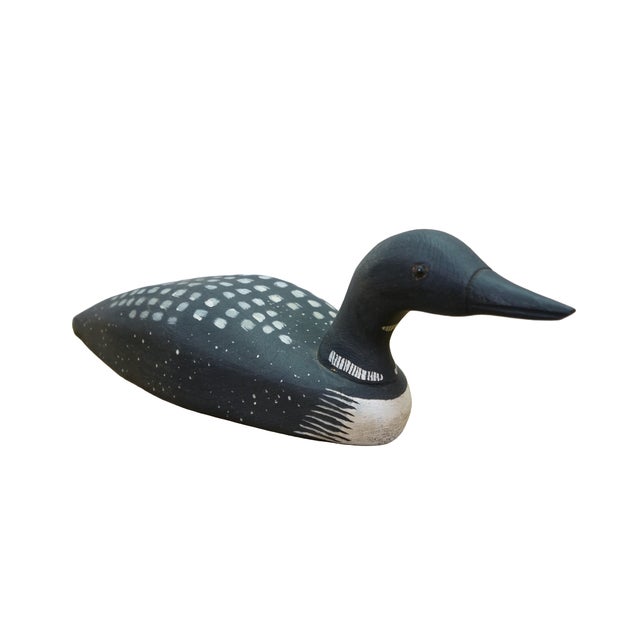 Exceptional folk art Common Loon decoy was meticulously handcrafted from solid white pine by the celebrated artisans at...